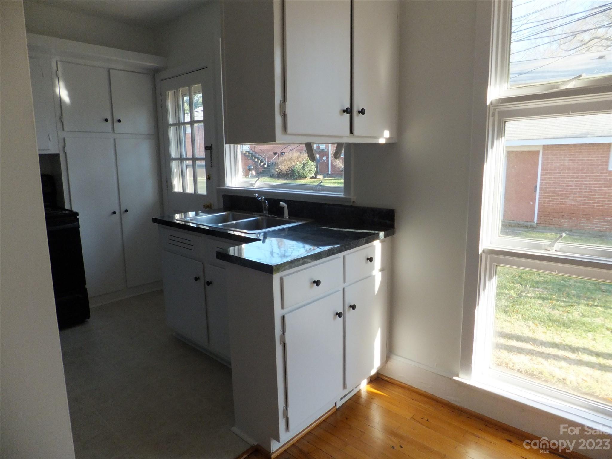 4222 Randolph Road Charlotte, NC 28211 - Photo 6 of 18 a kitchen with stainless steel appliances granite countertop a sink stove and refrigerator