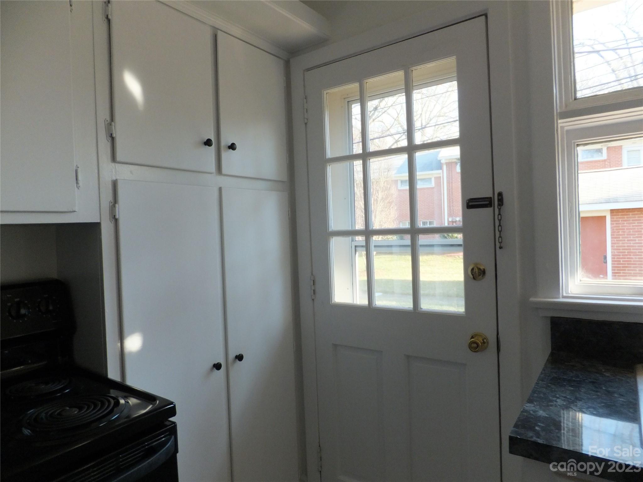 4222 Randolph Road Charlotte, NC 28211 - Photo 9 of 18 a kitchen with windows and refrigerator