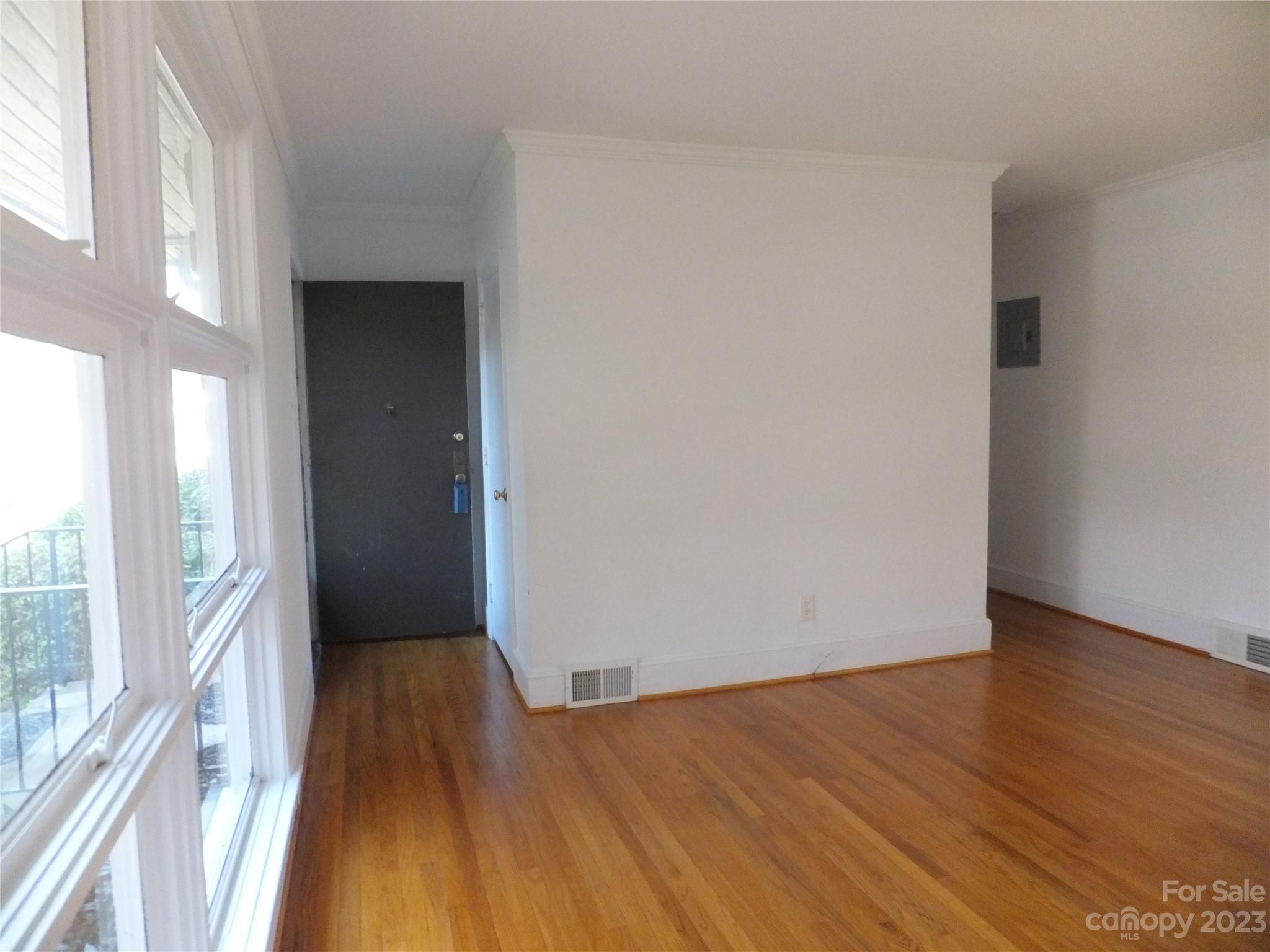 4222 Randolph Road Charlotte, NC 28211 - Photo 10 of 18 wooden floor in an empty room with a window