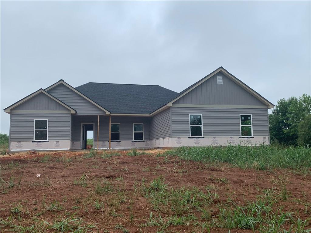 4139 Athens Road Carnesville, GA 30521 - Photo 1 of 1 a front view of house with yard and trees in the background