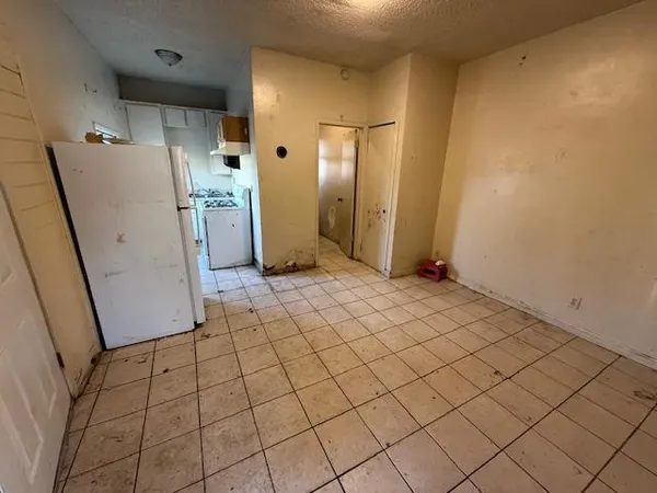 a view of a storage & utility room with refrigerator
