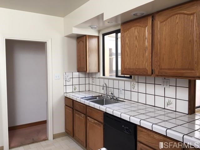 22 Shawnee Avenue San Francisco, CA 94112 - Photo 11 of 21 a kitchen with stainless steel appliances granite countertop a sink window and cabinets