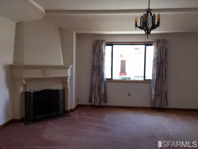 22 Shawnee Avenue San Francisco, CA 94112 - Photo 2 of 21 a view of an empty room with a fireplace and a window