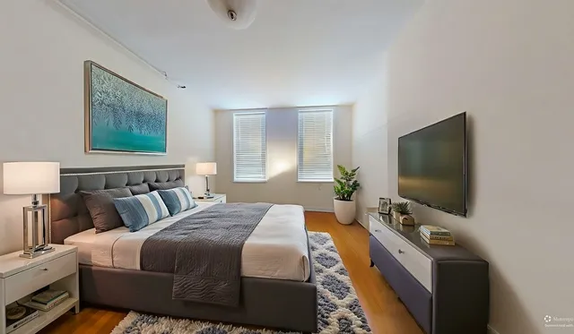 a bedroom with bed and window