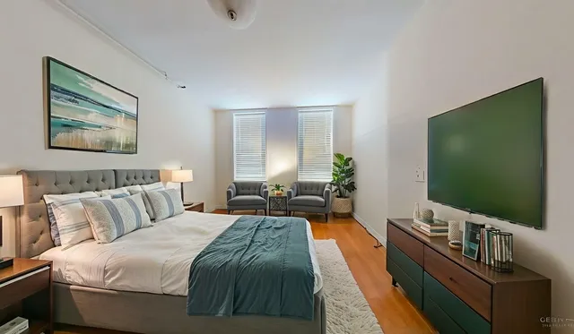 a bedroom with a bed and a flat screen tv