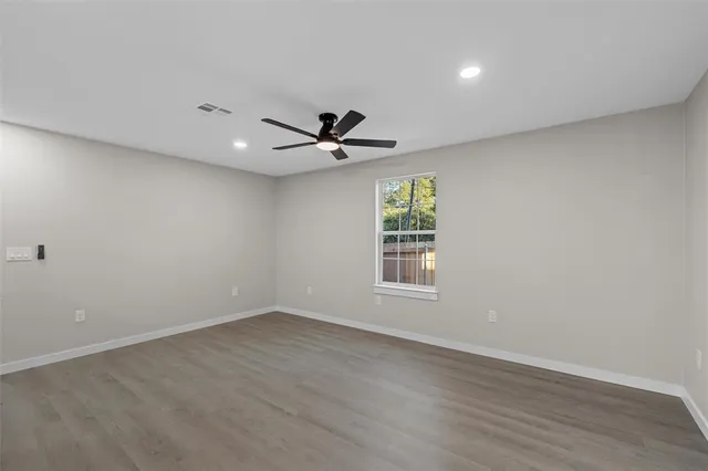 wooden floor in an empty room with a window
