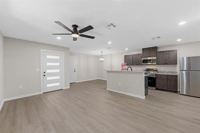 a view of kitchen with microwave a sink and dishwasher