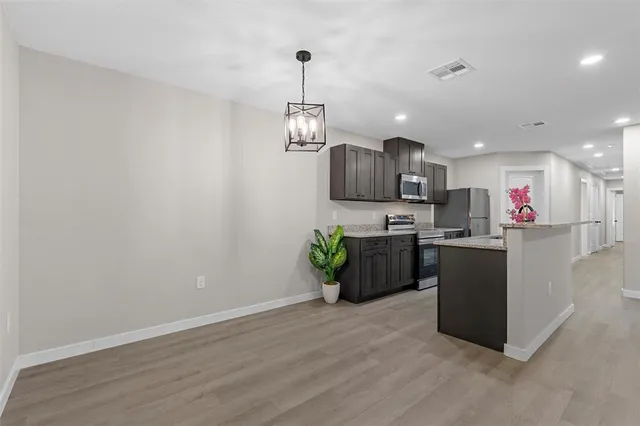 a kitchen with a refrigerator and a microwave