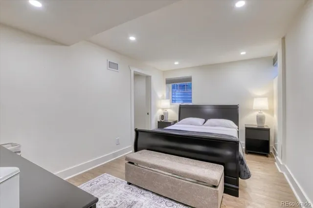 a bedroom with a bed and a lamp