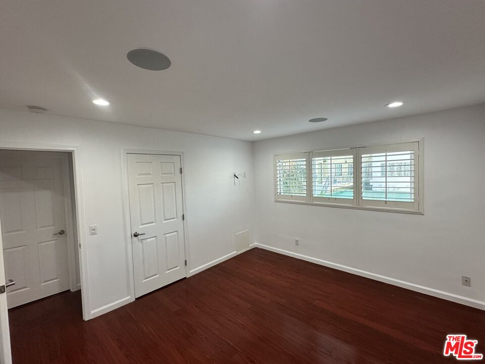 2721 2nd Street, Unit 207 Santa Monica, CA 90405 - Photo 3 of 11 a view of an empty room with wooden floor and a window