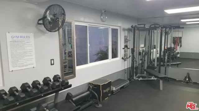 a room with gym equipment and a large window