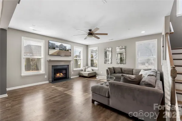 a living room with furniture a fireplace and a large window