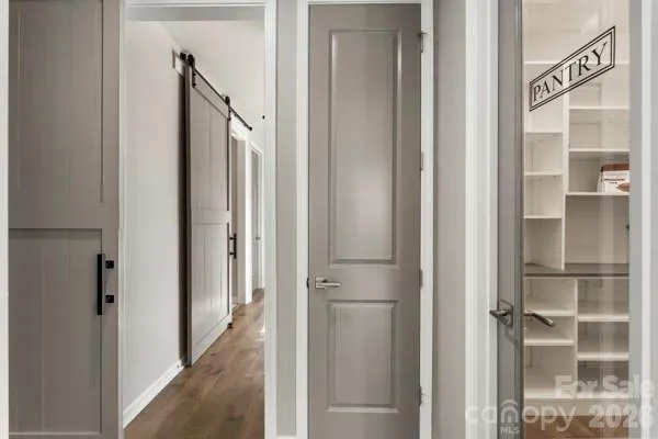 a view of a hallway with a door and stairs