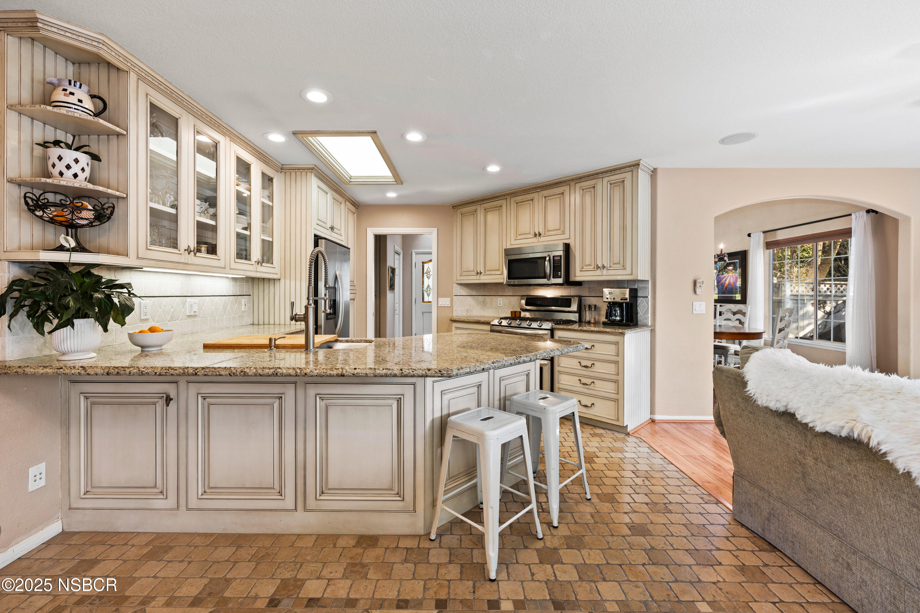 922 College Canyon Road Solvang, CA 93463 - Photo 7 of 23 a kitchen with kitchen island granite countertop wooden cabinets and refrigerator