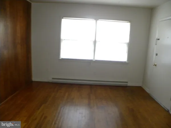 wooden floor and window in an empty room
