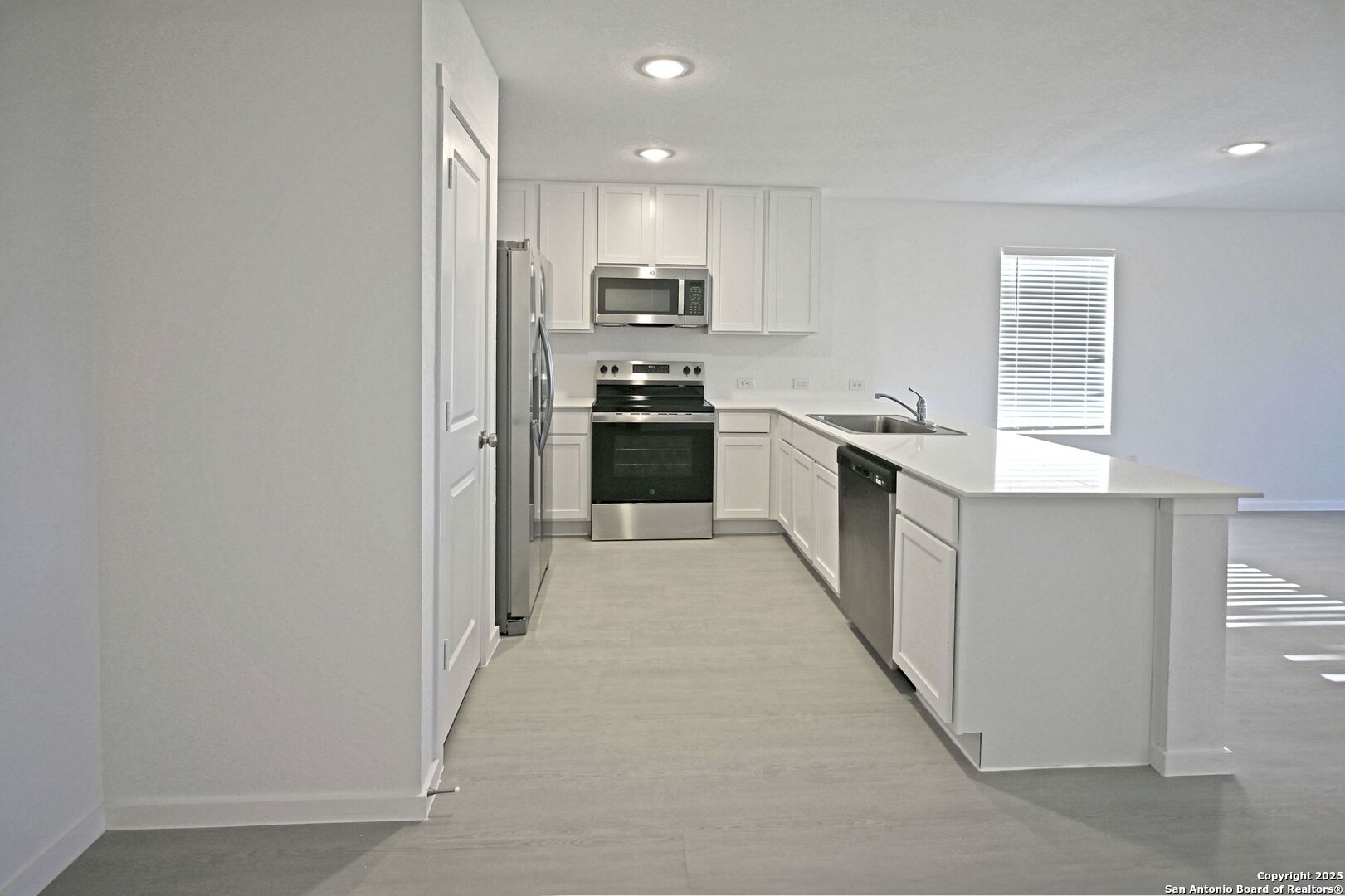 3837 Low Tide Seguin, TX 78155 - Photo 9 of 20 a kitchen with stainless steel appliances granite countertop a stove a sink and a refrigerator