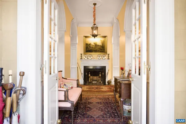 a view of a porch with furniture and floor to ceiling window