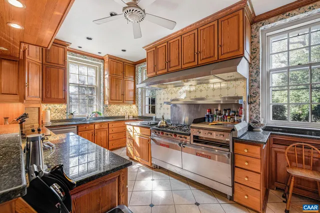 a large white bed sitting in a bedroom next to a window