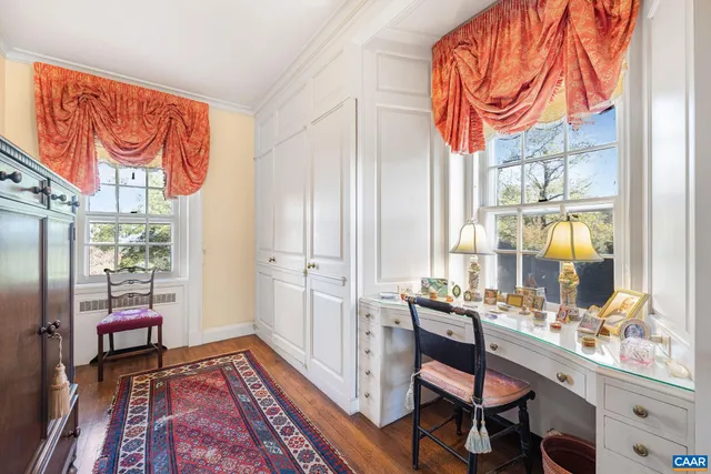 a utility room with stainless steel appliances lots of white furniture