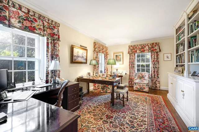 a view of a workspace with furniture and a workspace