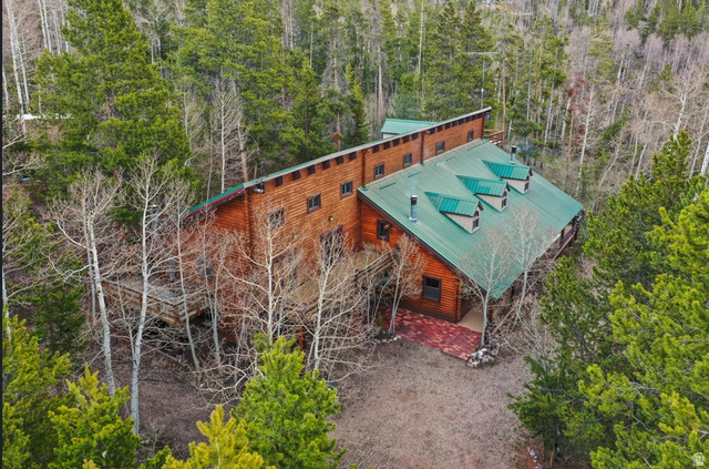 4725 Pine Ridge Road Evanston, UT 82930 - Photo 80 of 82 Wood-sided residence featuring a green metal roof with three dormers