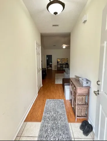 a hallway with furniture and a rug