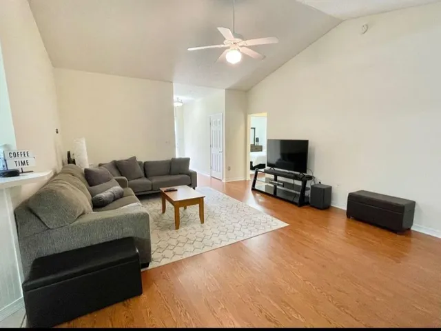 a living room with furniture and a flat screen tv