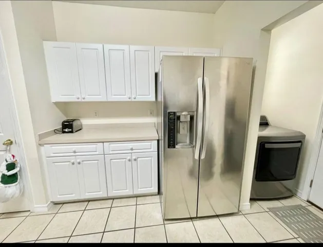 a kitchen with a refrigerator sink and cabinets