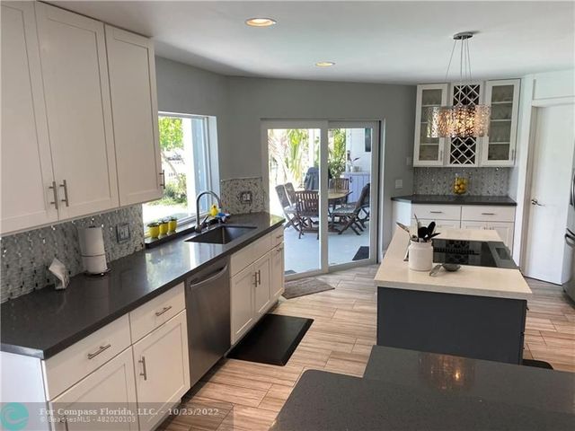 a bathroom with a sink toilet and wooden floor