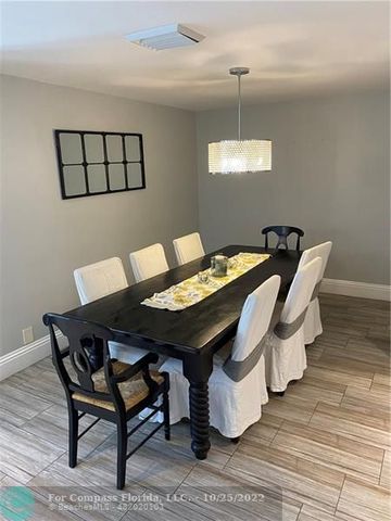 a bedroom with a bed and a dresser next to a window
