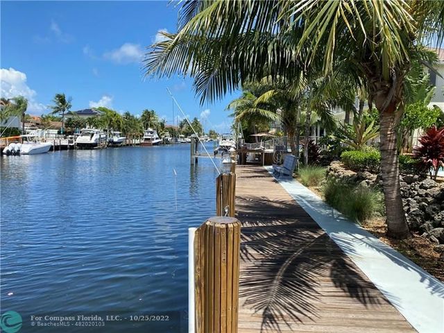 a living room with furniture a chandelier and a window