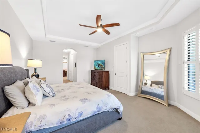 a spacious bedroom with a bed and a cabinets