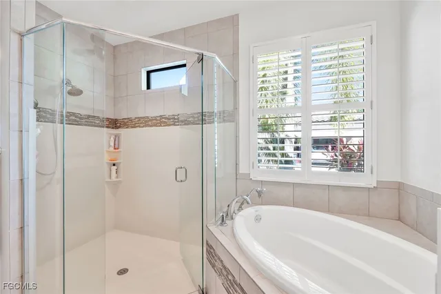 a bathroom with a bathtub and a shower