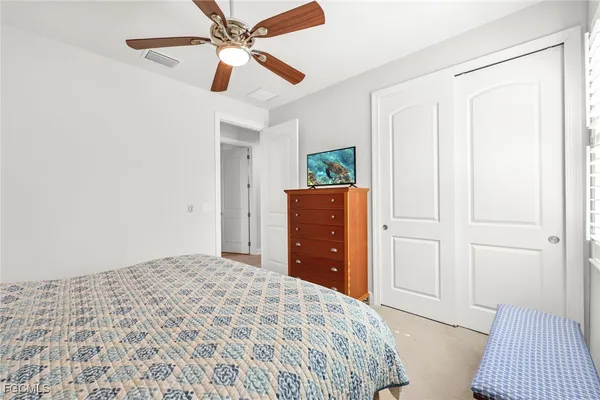 a bedroom with a bed and a dresser