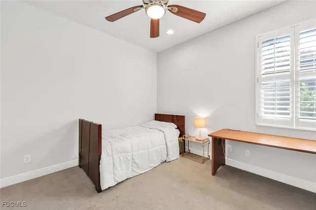 a bedroom with bed and window