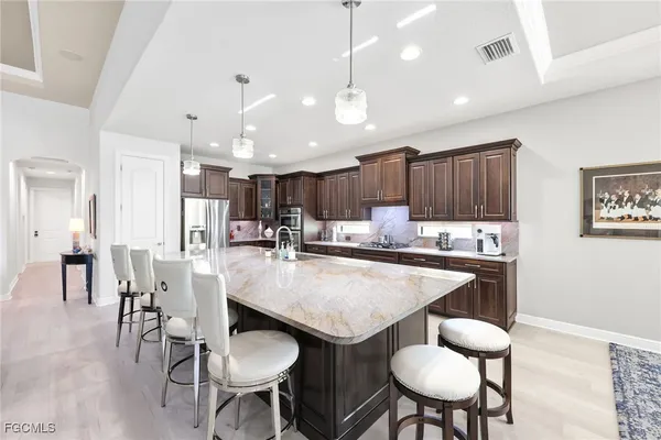 a large kitchen with a table and chairs