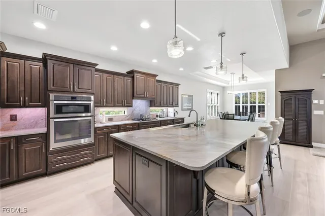 a kitchen with cabinets appliances and a center island