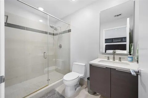 a bathroom with a sink toilet and shower