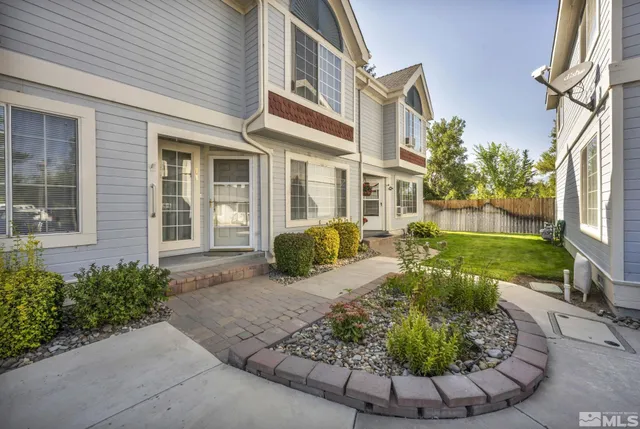 a view of a house with a chairs in patio