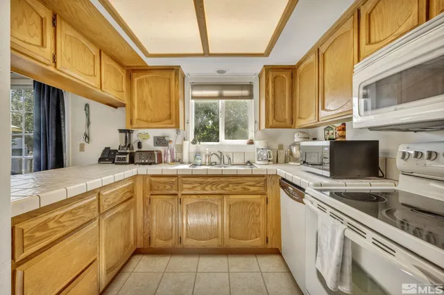 a kitchen with cabinets appliances a sink and a counter top space