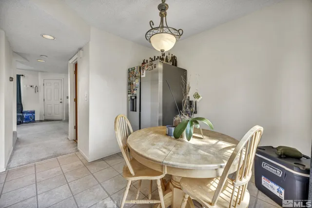 a view of a dining room with furniture and chandelier