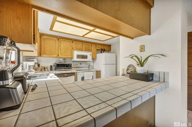 a kitchen with stainless steel appliances kitchen island granite countertop a sink and cabinets