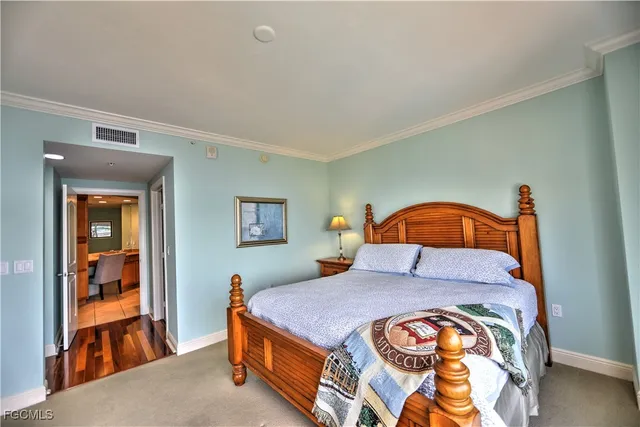 a bedroom with a bed and a painting on the wall