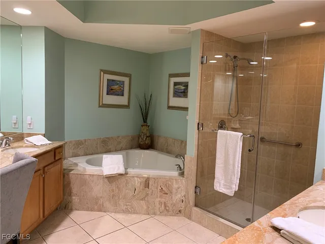 a bathroom with a tub sink and shower