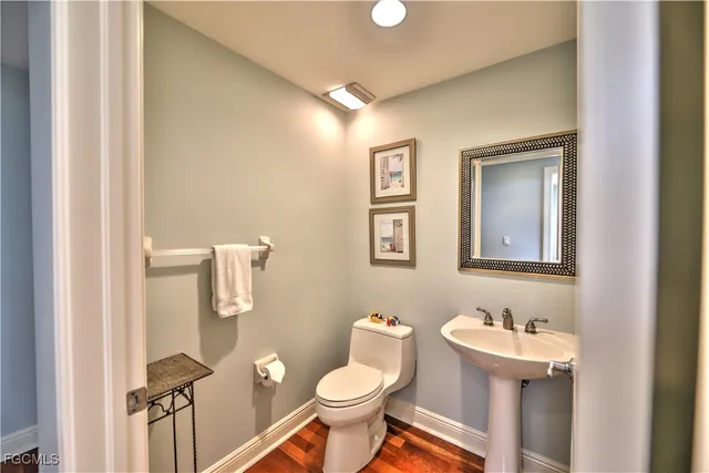 a bathroom with a toilet a sink and mirror