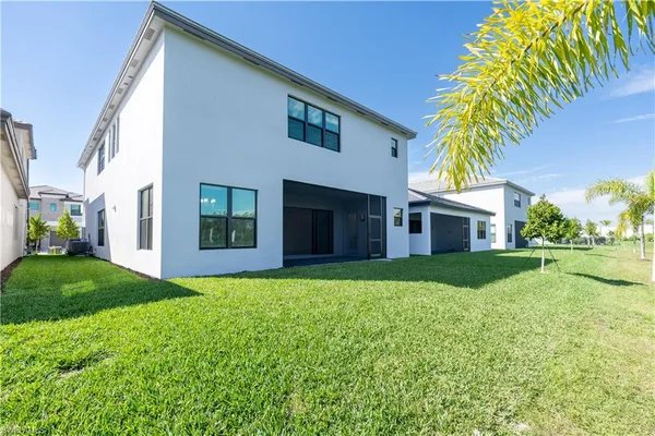a view of a house with a swimming pool and yard