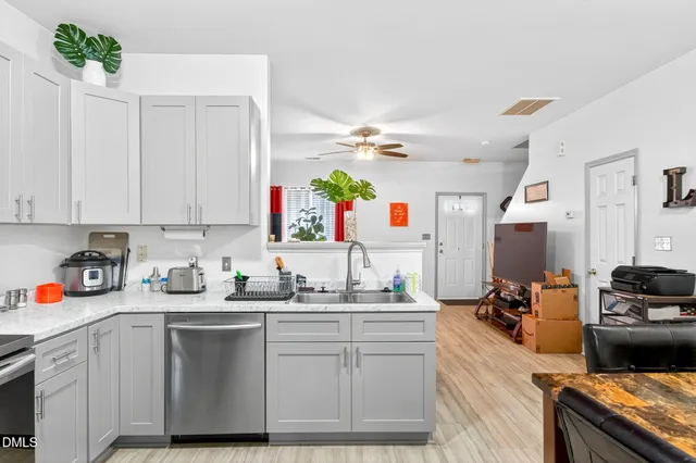 a kitchen with sink a stove and cabinets