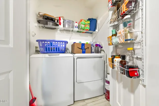 a utility room with fridge and cabinets
