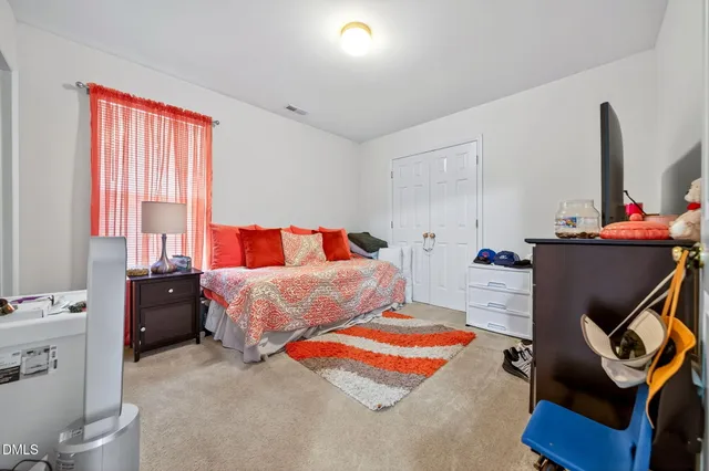 a bedroom with a bed and window