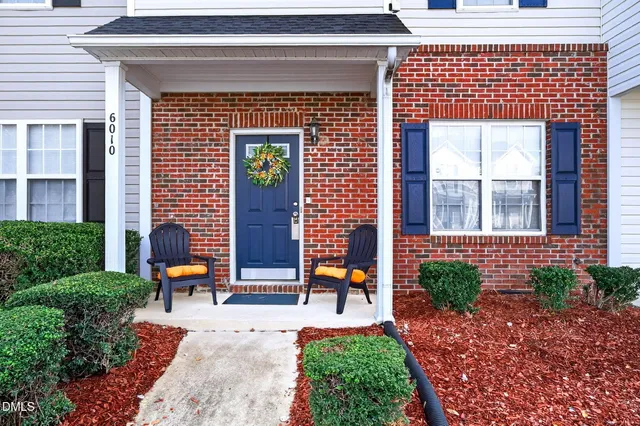 a front view of a house with outdoor seating